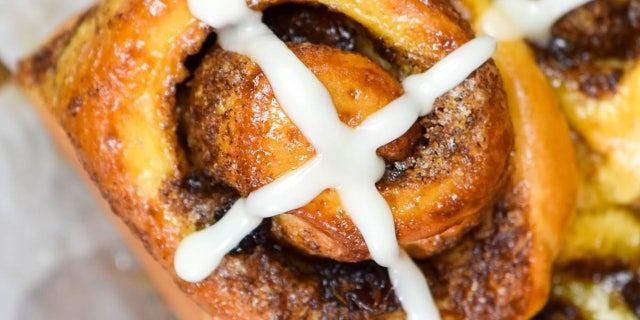 Finish the hot cross bun cinnamon rolls with an icing cross along the top of your baked treat.