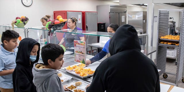 Students select their meal during a lunch break in the cafeteria at V. H. Lassen Academy of Science and Nutrition in Phoenix, Arizona, on Jan. 31, 2023.