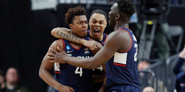 Nahiem Alleyne #4 of the Connecticut Huskies celebrates with teammates after scoring during the second half against the Gonzaga Bulldogs in the Elite Eight round of the NCAA Men's Basketball Tournament at T-Mobile Arena on March 25, 2023 in Las Vegas, Nevada.