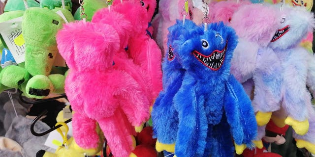 Stuffed Huggy Wuggy toys of various colors are shown for sale in Poland.