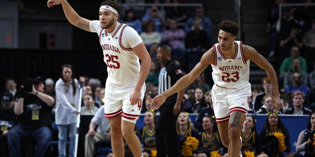 Race Thompson #25 and Trayce Jackson-Davis #23 of the Indiana Hoosiers react in the first half against the Kent State Golden Flashes during the first round of the NCAA Men's Basketball Tournament at MVP Arena on March 17, 2023 in Albany, New York.