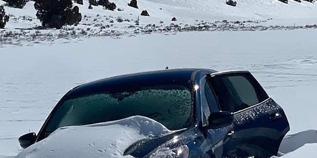 A helicopter crew spotted a partly snow-covered vehicle with the missing man waving inside.