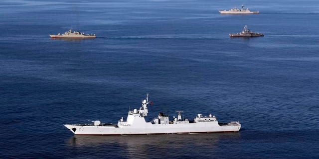 Warships sail in the Sea of Oman during the second day of joint Iran, Russia and China naval war games on Dec. 28 2019.