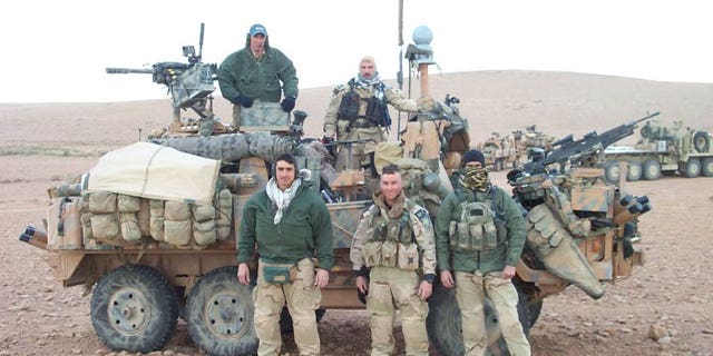 This picture was taken at the border of Saudi Arabia and Iraq right before the initial invasion on March 19, 2003. Pictured standing together on the right are Craig Palmer and Chris VanSant.