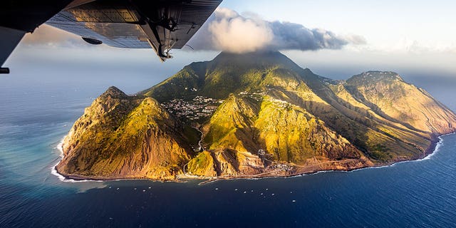 A plane flies over the Island of Saba, St. Eustatius, on Feb. 9, 2023.