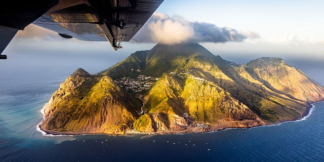 A plane flies over the Island of Saba, St. Eustatius, on Feb. 9, 2023.