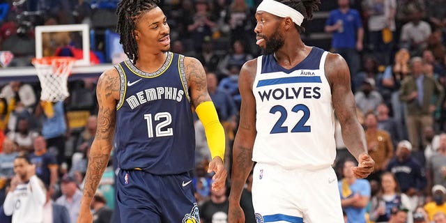 Ja Morant #12 of the Memphis Grizzlies and Patrick Beverley #22 of the Minnesota Timberwolves smile during Round 1 Game 5 on April 26, 2022 at FedExForum in Memphis, Tennessee. 