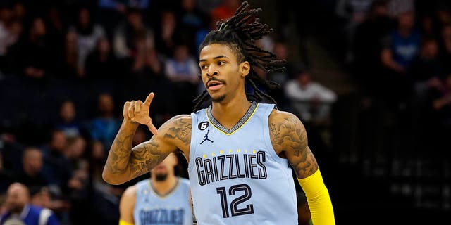 Ja Morant, #12 of the Memphis Grizzlies, celebrates making his three-point basket against the Minnesota Timberwolves in the first quarter of the game at the Target Center on November 30, 2022 in Minneapolis.