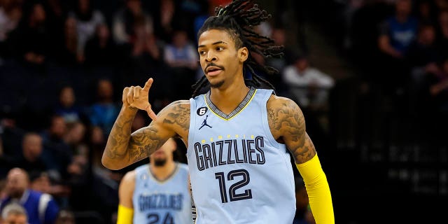 Ja Morant, #12 of the Memphis Grizzlies, celebrates making his three-point basket against the Minnesota Timberwolves in the first quarter of the game at the Target Center on November 30, 2022 in Minneapolis.