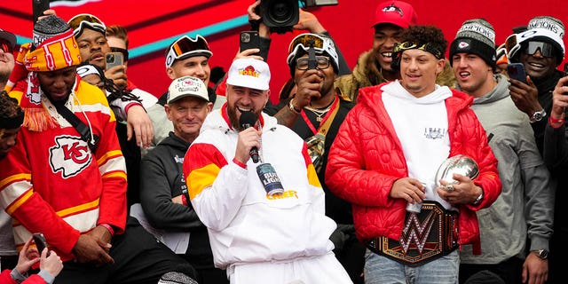 Travis Kelce #87 and Patrick Mahomes #15 of the Kansas City Chiefs celebrate on stage with teammates during the Kansas City Chiefs Super Bowl LVII victory parade on February 15, 2023, in Kansas City, Missouri. 