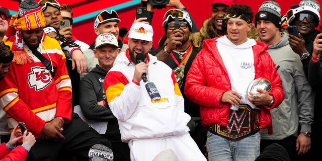 Travis Kelce #87 and Patrick Mahomes #15 of the Kansas City Chiefs celebrate on stage with teammates during the Kansas City Chiefs Super Bowl LVII victory parade on February 15, 2023, in Kansas City, Missouri. 