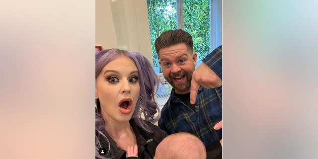 A photo of Kelly Osbourne with brother Jack and her baby