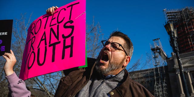A person holding a sign shouts during a rally to protest the passage of SB 150 March 29, 2023 at the Kentucky State Capitol in Frankfort, Kentucky.