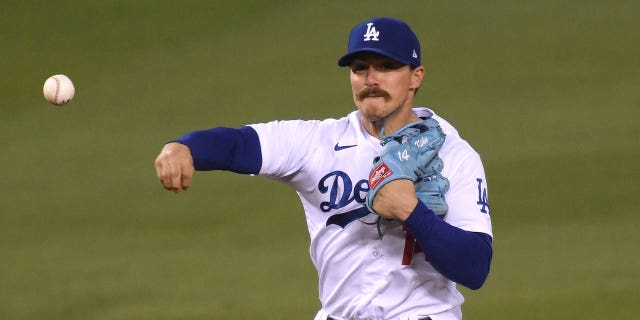 Enrique Hernandez of the Los Angeles Dodgers turns a double play during the eighth inning against the San Diego Padres at Dodger Stadium Aug. 12, 2020, in Los Angeles. 