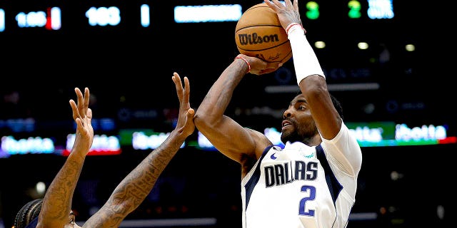 Kyrie Irving, #2 of the Dallas Mavericks, shoots over Naji Marshall, #8 of the New Orleans Pelicans, during the fourth quarter of an NBA game at Smoothie King Center on March 8, 2023, in New Orleans, Louisiana.