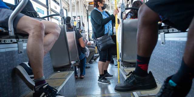 People ride a Metro bus in Los Angeles on July 14, 2022.
