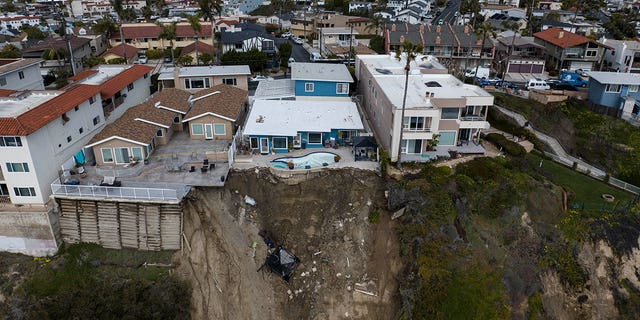 A residential swimming pool hangs on a cliff side after a landslide occurred in San Clemente, California, on March 16, 2023. 