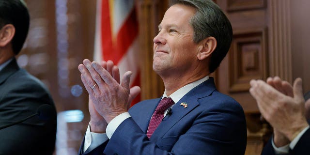 Georgia Gov. Brian Kemp applauds on the House floor of the state Capitol, on Jan. 25, 2023, in Atlanta. The state Senate voted on March 7, 2023, to pass a bill that would allow some pregnant women to apply for cash aid, a proposal that Kemp backed.