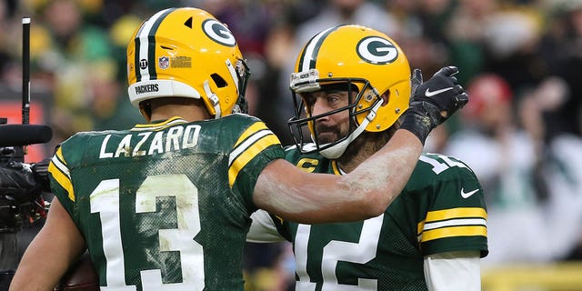 Packers wide receiver Allen Lazard celebrates with quarterback Aaron Rodgers during the Cleveland Browns game on Dec. 25, 2021, at Lambeau Field in Green Bay, Wisconsin.