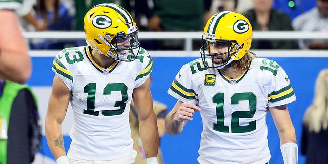 Green Bay Packers wide receiver Allen Lazard (13) talks with quarterback Aaron Rodgers (12) after a play during a game against the Detroit Lions in Detroit Jan. 9, 2022.