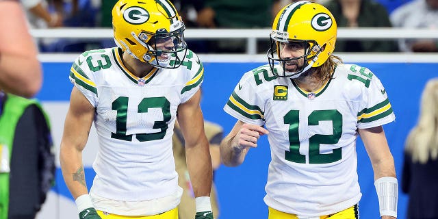 Green Bay Packers wide receiver Allen Lazard (13) talks with quarterback Aaron Rodgers (12) after a play during a game against the Detroit Lions in Detroit Jan. 9, 2022.