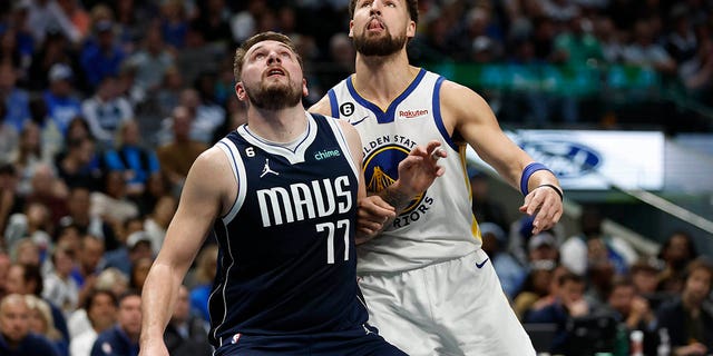 Luka Doncic #77 of the Dallas Mavericks and Klay Thompson #11 of the Golden State Warriors battle for position in the first half at the American Airlines Center on March 22, 2023 in Dallas, Texas.