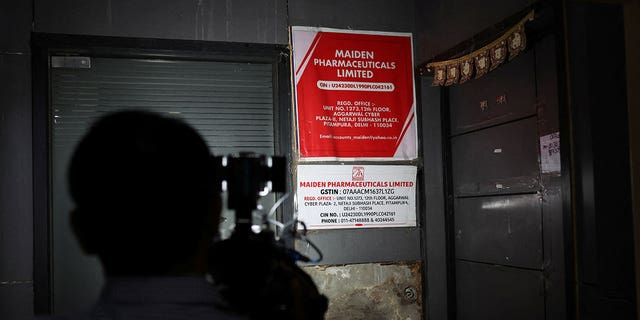 A cameraman takes visuals outside the office of Maiden Pharmaceuticals Ltd. Company in New Delhi, India, on Oct. 6, 2022.