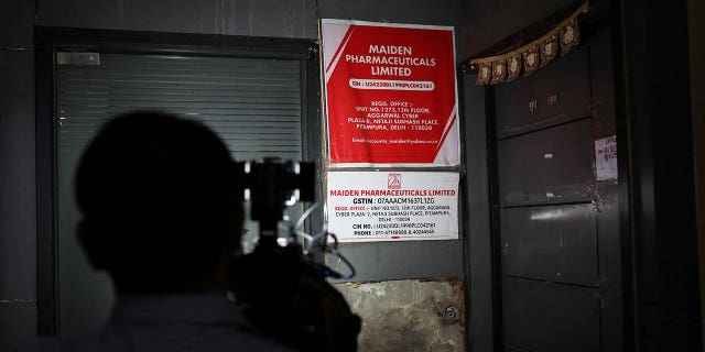 A cameraman takes visuals outside the office of Maiden Pharmaceuticals Ltd. Company in New Delhi, India, on Oct. 6, 2022.