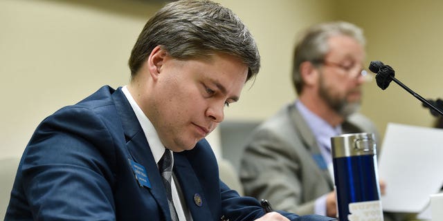 Rep. Jeremy Trebas takes notes during a meeting in Helena, Montana, on Jan. 14, 2021. Trebas is sponsoring legislation that would block diversity training for state employees.