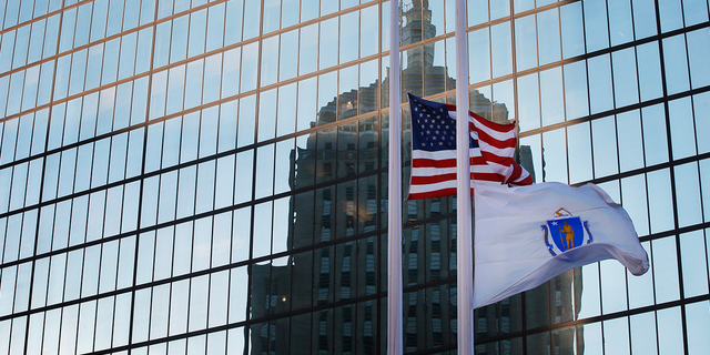 The U.S. and Massachusetts flags fly at half staff in Boston.