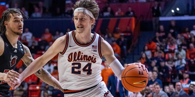 Matthew Mayer, #24 of the Illinois Fighting Illini, drives to the basket against Caleb McConnell, #22 of the Rutgers Scarlet Knights, at State Farm Center on Feb. 11, 2023 in Champaign, Illinois.