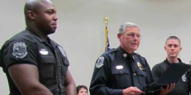 Ty McGowan, left, receive special recognition from the La Vergne police chief in 2011.