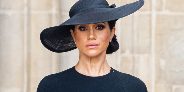 Meghan Markle wears a black dress and a black hat at Queen Elizabeths funeral.