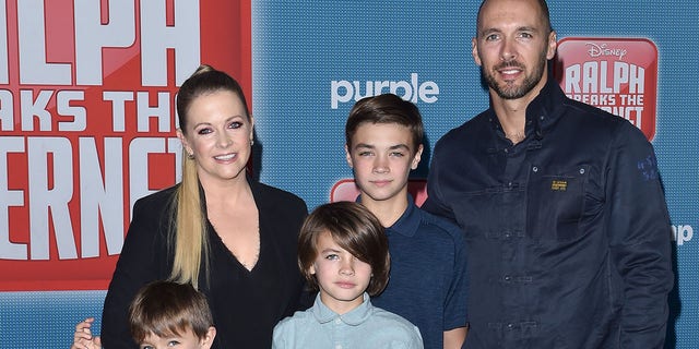 Melissa Joan Hart poses for a family photo with her husband, Mark Wilkerson, and their children, Tucker, Braydon and Mason.