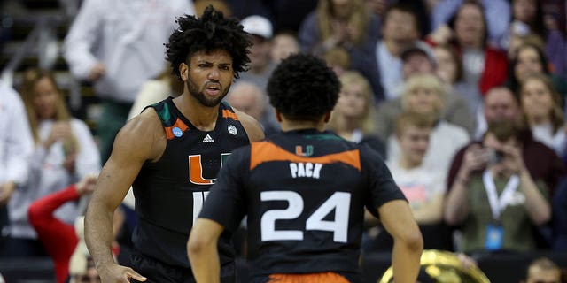 Norchad Omier #15 of the Miami Hurricanes reacts after scoring with teammate Nijel Pack #24 during the first half against the Houston Cougars in the Sweet 16 round of the NCAA Men's Basketball Tournament at T-Mobile Center on March 24, 2023 in Kansas City, Missouri. 