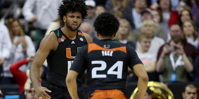 Norchad Omier #15 of the Miami Hurricanes reacts after scoring with teammate Nijel Pack #24 during the first half against the Houston Cougars in the Sweet 16 round of the NCAA Men's Basketball Tournament at T-Mobile Center on March 24, 2023 in Kansas City, Missouri. 