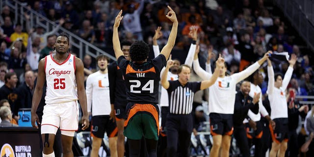 Nijel Pack #24 of the Miami Hurricanes celebrates a three-point basket against Jarace Walker #25 of the Houston Cougars during the second half in the Sweet 16 round of the NCAA Men's Basketball Tournament at T-Mobile Center on March 24, 2023, in Kansas City, Missouri. 