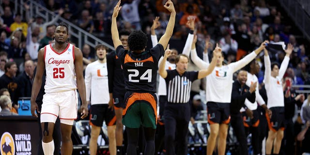 Nijel Pack #24 of the Miami Hurricanes celebrates a three-point basket against Jarace Walker #25 of the Houston Cougars during the second half in the Sweet 16 round of the NCAA Men's Basketball Tournament at T-Mobile Center on March 24, 2023, in Kansas City, Missouri. 