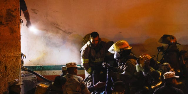 Mexican authorities and firefighters remove injured migrants, mostly Venezuelans, from inside the National Migration Institute (INM) building during a fire, in Ciudad Juarez, Mexico on March 27, 2023.