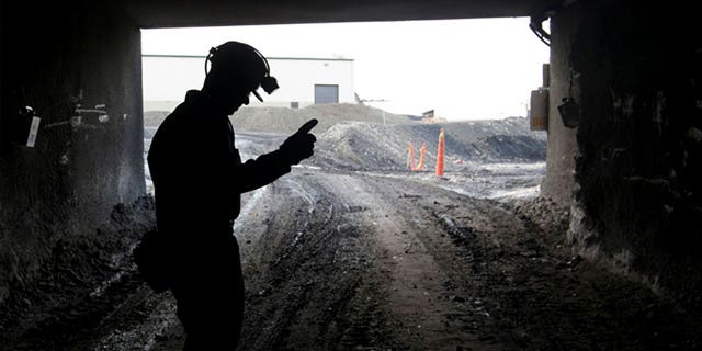 An employee stands in the entry of the Signal Peak Energy's Bull Mountain mine in Roundup, Montana, on Nov. 9, 2010. Authorities said March 1, 2023, that three workers were injured in a collapse at the underground coal mine.