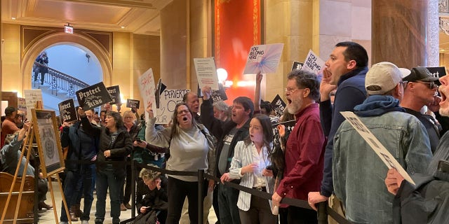 Dozens of protesters chanted for and against a bill that would make Minnesota a trans refuge state, which is a counter to states attempting to ban transgender care for minors, Thursday, March 23, 2023, in St. Paul, Minnesota.