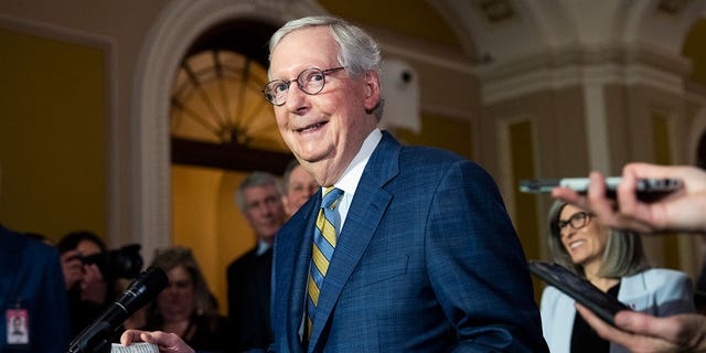 Sen. Mitch McConnell smiles as he walks through Capitol Hill