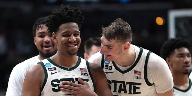 AJ Hoggard (11) and Carson Cooper (15) of the Michigan State Spartans celebrate after a basket against the USC Trojans during the second half of an NCAA men's basketball tournament first round game at Nationwide Arena on March 17. 2023 in Columbus, USA. Ohio. 
