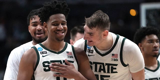 AJ Hoggard (11) and Carson Cooper (15) of the Michigan State Spartans celebrate after a basket against the USC Trojans during the second half of an NCAA men's basketball tournament first round game at Nationwide Arena on March 17. 2023 in Columbus, USA. Ohio. 