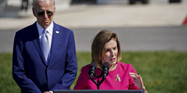 Former House Speaker Rep. Nancy Pelosi, D-Calif., speaks with President Biden listening behind her on Aug. 9, 2022. Pelosi spoke at a University of Chicago event on Friday, where she complained that Biden did not give House Democrats a "heads up" that he would sign legislation overturning Washington, D.C.'s revised criminal code. 