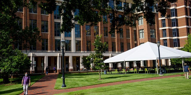 Students and faculty walk through an open area on the campus of the University of North Carolina at Chapel Hill on Aug. 18, 2020, in Chapel Hill, North Carolina. The North Carolina House has approved a bill requiring college students to take a U.S. history or government class.