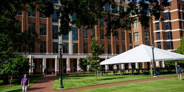 Students and faculty walk through an open area on the campus of the University of North Carolina at Chapel Hill on Aug. 18, 2020, in Chapel Hill, North Carolina. The North Carolina House has approved a bill requiring college students to take a U.S. history or government class.