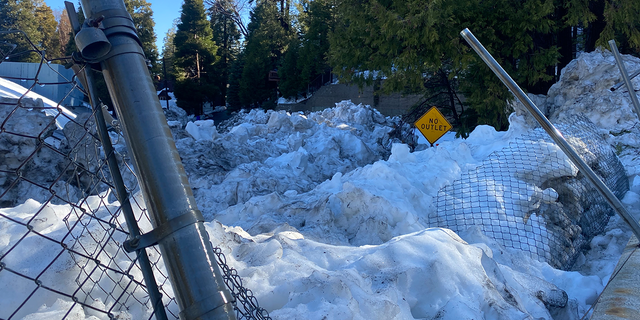 The leftover snow from a rare blizzard in southern California is as tall as a "no outlet" street sign, three weeks after.