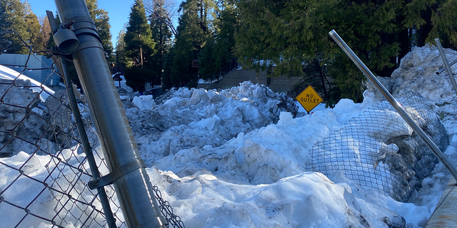 The leftover snow from a rare blizzard in southern California is as tall as a "no outlet" street sign, three weeks after.