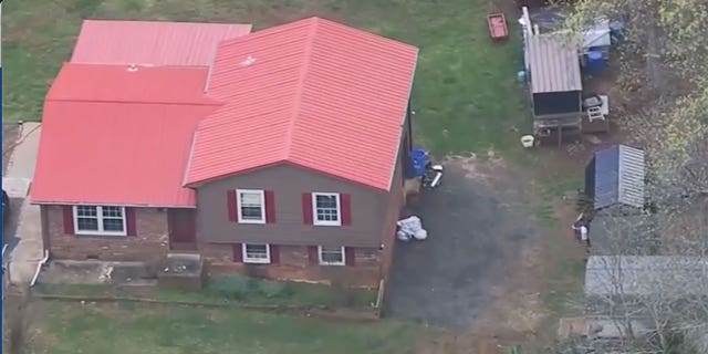 Aerial shot of North Carolina house with red roof and shed